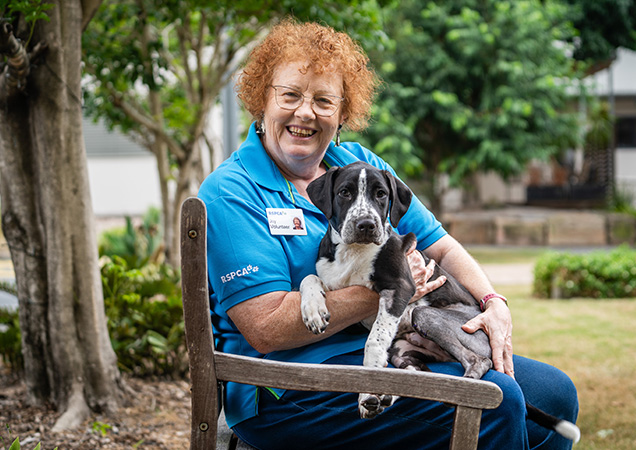 Volunteer Joy with Wallace the puppy.